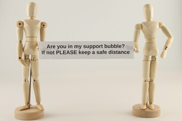 Are you in my support bubble, if not please keep a safe distance sign held by two manikins