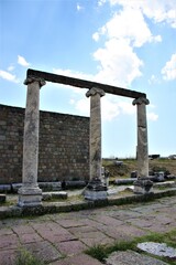 Fototapeta premium Theatre of The Asclepion of Pergamon Ancient City. Bergama, Izmir, Turkey. Relics, Roman columns, gates during sunny day and blue sky.
