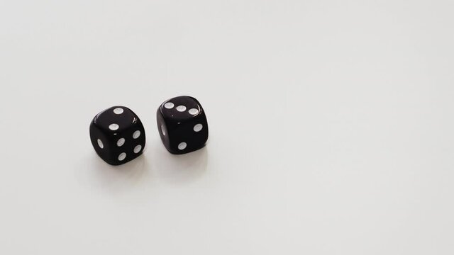 Male hands throwing double dice on white table. Two and three on dice cubes at playing table. Concept gambling and casino game