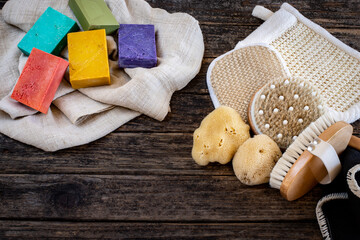 Many kinds of bath sponges on the wooden table