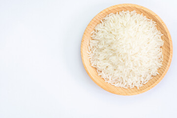 Fototapeta na wymiar Heap of raw rice on wooden bowl 
