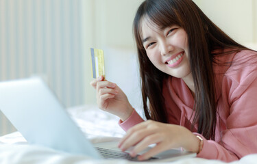 Young Asian woman holding credit card