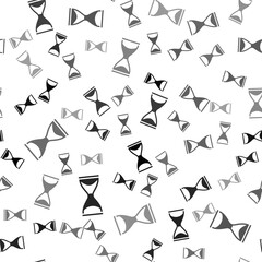 Black Old hourglass with flowing sand icon isolated seamless pattern on white background. Sand clock sign. Business and time management concept. Vector.