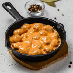 French onion meatballs in cast iron skillet. space for text.