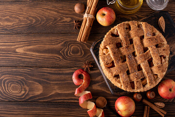 apple pie from autumn apples with cinnamon and honey on a wooden table