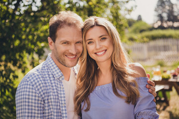 Fototapeta premium Photo of family two people husband wife lovers spend honeymoon embrace toothy beaming smile enjoy vacation prepare picnic wait children relax summer day green home park backyard outside