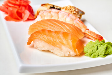 Nigiri sushi with salmon on the white plate