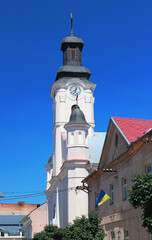 Fototapeta na wymiar St. George Church in Uzhhorod city. It is a Roman Catholic church built in 1762-1766 in a late Baroque style. City clock placed on the tower. Transcarpathia, Western Ukraine.