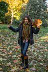 Girl with autumn leaves and very happy emotions