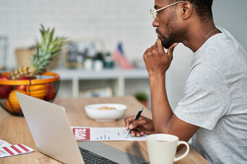 Side view of black man voting from home