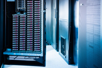 an opened door of data center cabinet filled with data storage h