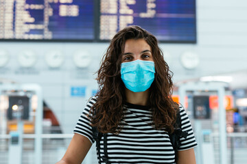 Portrait of a young woman wearing a face mask on the airport