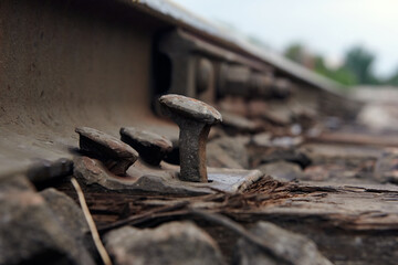 Close up old rusty nail with wooden sleepers.