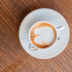 cappuccino coffee cup top vew closeup on wooden table