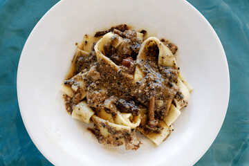 Top view of pappardelle pasta dish with dish truffle and mushrooms a typical Italian plate from Abruzzo region
