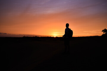 Fototapeta na wymiar Silhouette of a man watching the sunset.