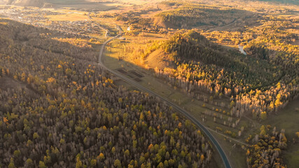Naklejka premium Aerial panorama from drone over a river and fall forest. Autumn nature landscape