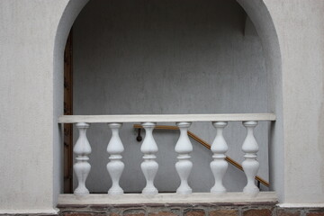 White historic building with balcony and columns.