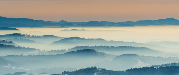 Amazing mountain scenery with hills and mist from Barania Gora hill in Beskid Slaski mountains in Poland