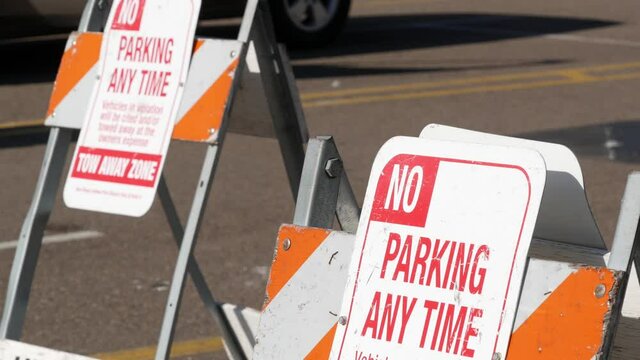 Parking lot sign as symbol of traffic difficulties and transportation issues in busy urban areas of USA. Public paid parking zone in downtown of San Diego, California. Limited space for cars in city.