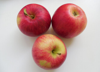 3 ripe fresh apples on a neural background