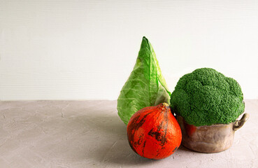 Fresh ripe pointed cabbage, broccoli and orange pumpkin assortment. Copy space.