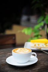 A cup of coffee with a picture on the coffee foam