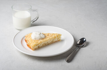 Healthy breakfast made from soft cottage cheese casserole , served with sour cream and  milk.