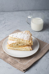 Homemade rustic pie with cottage cheese and milk   on a gray backgroun
