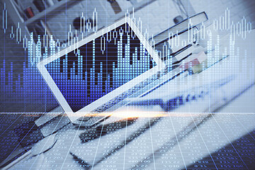 Financial graph colorful drawing and table with computer on background. Multi exposure. Concept of international markets.