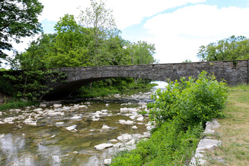 Fototapeta na wymiar Stone bridge over Taughannock creek at Taughannock Falls State Park