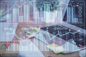 Multi exposure of graph and financial info and work space with computer background. Concept of...