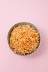 tomato rice in bowl on pink background