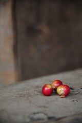 Red coffee beans placed on brown wood floors