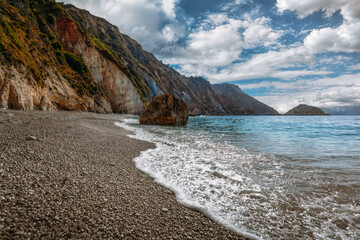 Petani beach and waves hitting steep cliffs