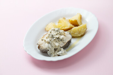 boiled fish with sauce tartar and boiled potato on white dish