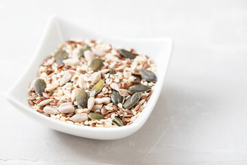 assorted seeds in the small white bowl