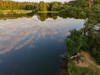 lake in the middle of the forest beautiful nature trees clouds reflection