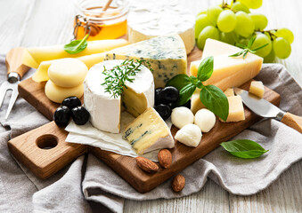 Various types of cheese  on a white wooden  background