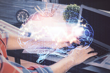 Man with computer background with brain theme hologram. Concept of brainstorm. Double exposure.