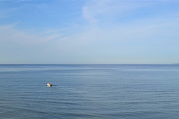 Horizon line: Marmara Sea and blue sky. Coast, blue sea, beach, rocky, raft in the same photo...