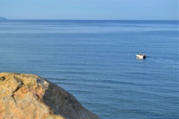 Horizon line: Marmara Sea and blue sky. Coast, blue sea, beach, rocky, raft in the same photo during sunny day of Mudanya, Bursa, Turkey.