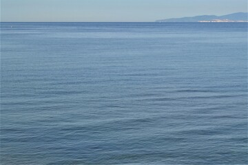 Horizon line: Marmara Sea and blue sky. Coast, blue sea, beach, rocky, raft in the same photo during sunny day of Mudanya, Bursa, Turkey.