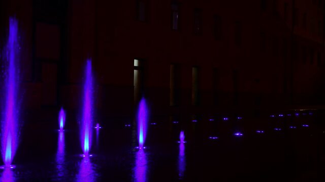 Beautiful musical fountain with colorful illumination in the evening in Kiev Ukraine 4k video