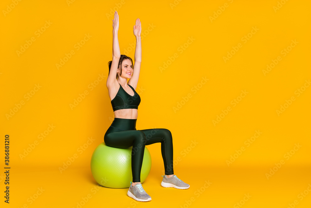 Canvas Prints photo of sportive lady sit big fit ball focused raise arms up wear sports suit top pants sneakers is