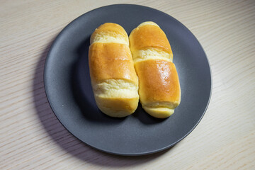 Two small breads on a plate.