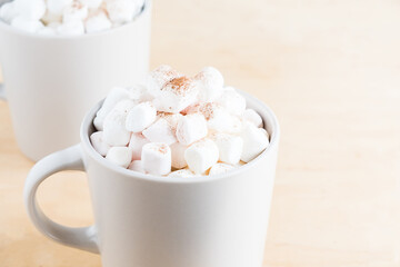 Fototapeta na wymiar Cup of hot cocoa with marshmallows on wooden background