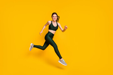 Fototapeta na wymiar Full length profile photo of lady jump high up training marathon finish line wear sports suit shoes isolated yellow color background