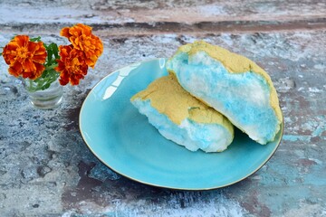 Cloud Bread with Blue and White Color, with Marigold flower decoration. Roti Awan