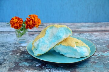 Cloud Bread with Blue and White Color, with Marigold flower decoration. Roti Awan